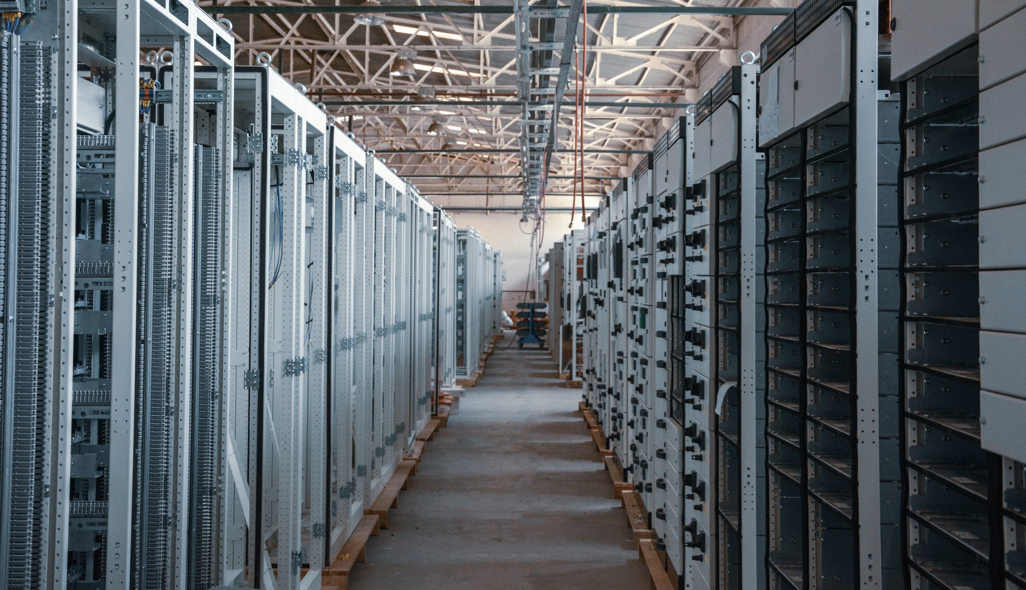 Rows of industrial electrical switchgear panels in a mission-critical facility